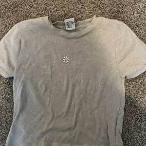 tan shirt with a flower